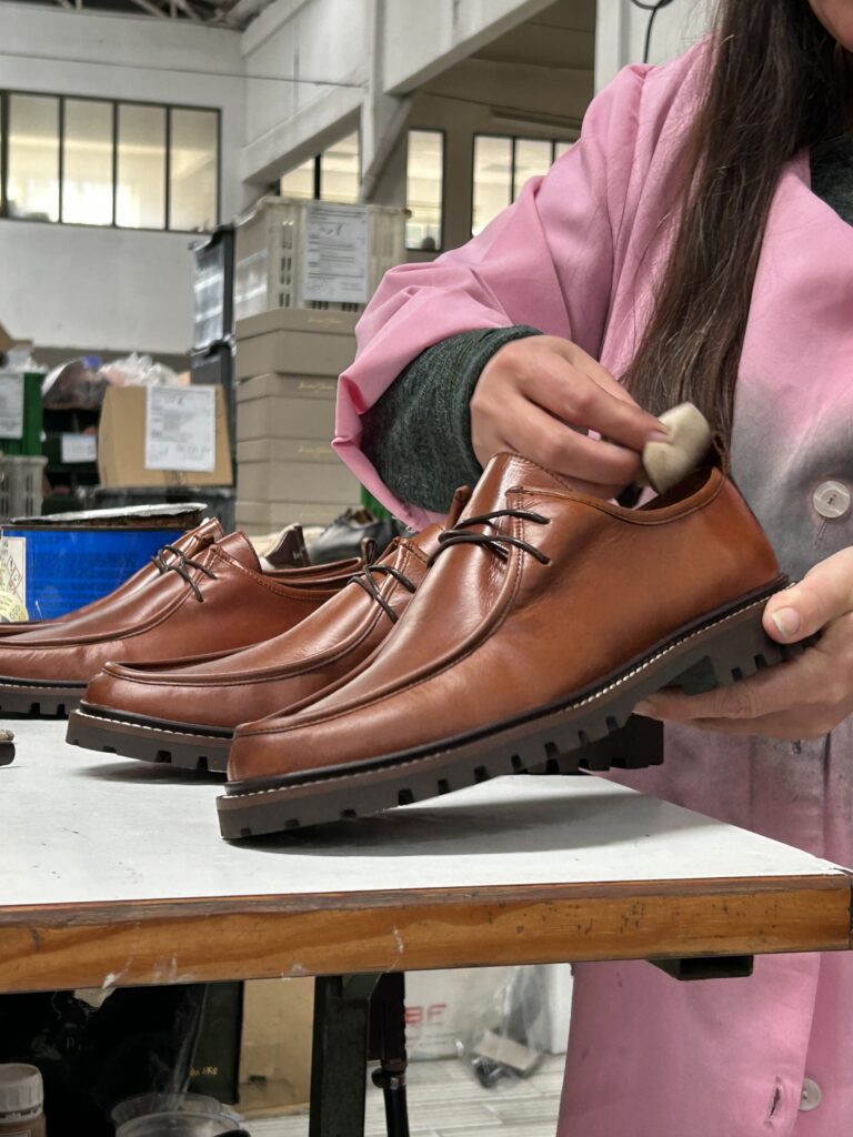 Woman manufacturing a shoe